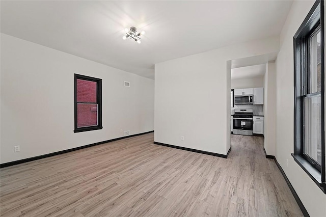 unfurnished room featuring light hardwood / wood-style flooring