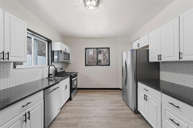 kitchen with white cabinetry, sink, appliances with stainless steel finishes, and tasteful backsplash