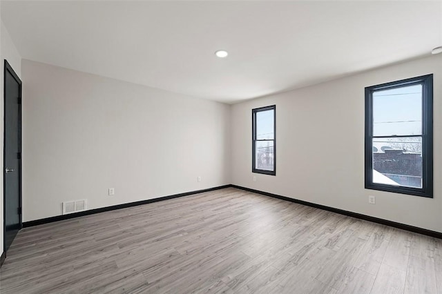 unfurnished room featuring light hardwood / wood-style floors