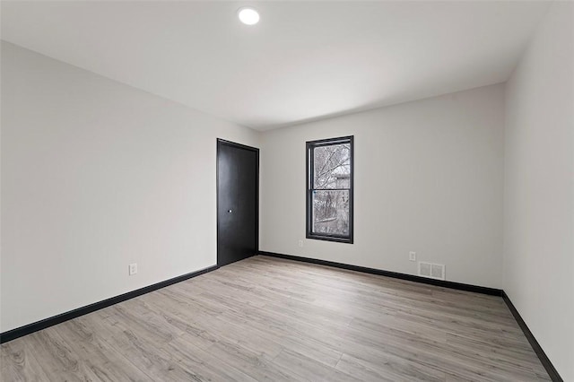 spare room with light hardwood / wood-style floors