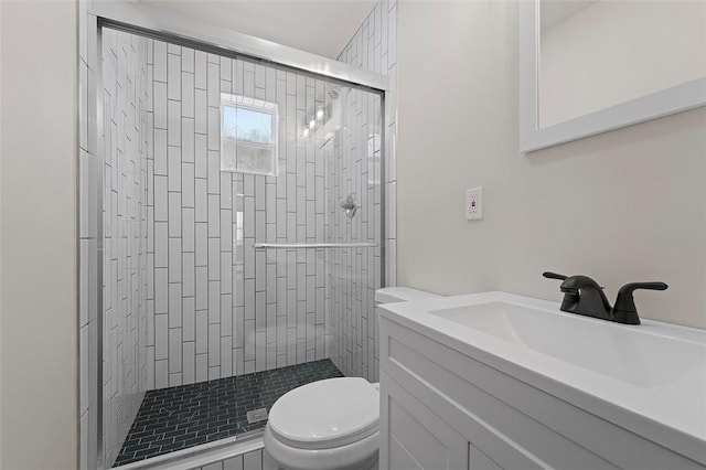 bathroom with walk in shower, vanity, and toilet