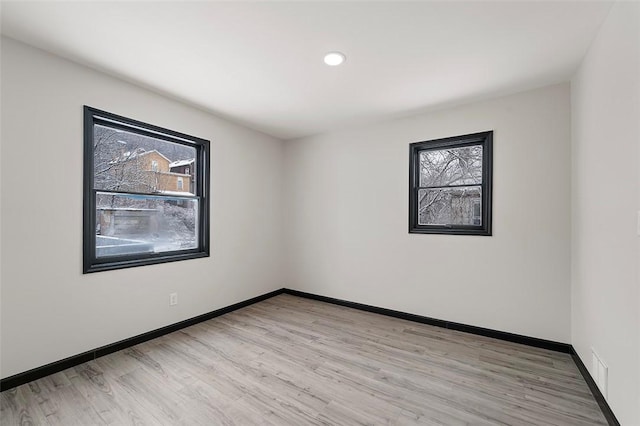 spare room with light wood-type flooring