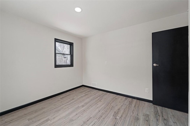 unfurnished room with light hardwood / wood-style floors