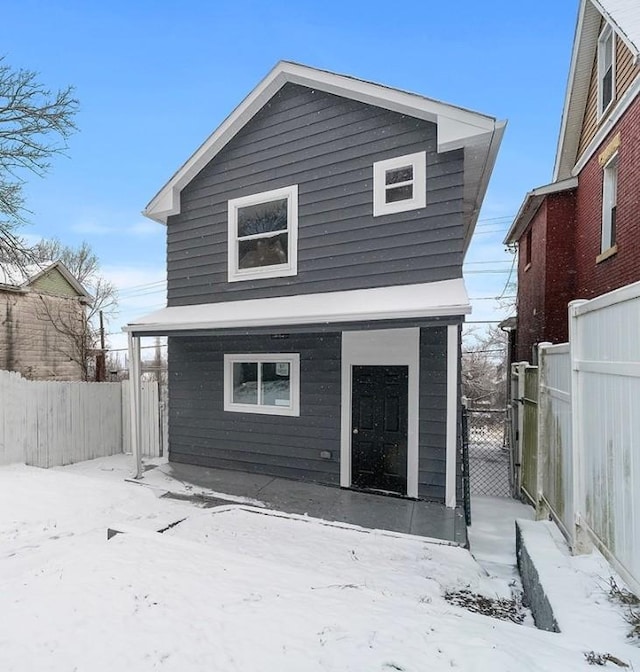 view of snow covered rear of property