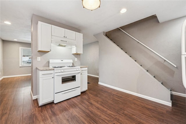 kitchen with white range with gas stovetop, white cabinetry, light stone countertops, and dark wood-type flooring