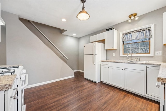 kitchen featuring pendant lighting, white appliances, dark wood-type flooring, white cabinets, and sink