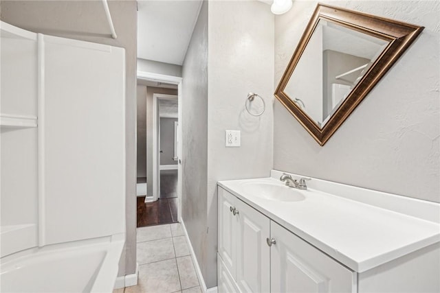 bathroom featuring bathtub / shower combination, vanity, and tile patterned floors