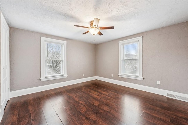 spare room featuring dark hardwood / wood-style floors and ceiling fan