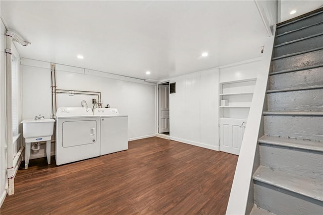 laundry area with separate washer and dryer, built in features, dark hardwood / wood-style floors, and sink