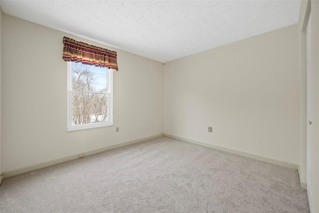 empty room with carpet floors and a textured ceiling