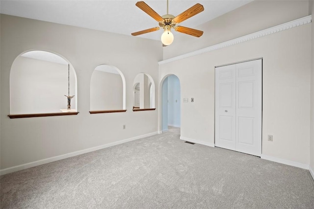 unfurnished bedroom with ceiling fan, carpet floors, and a closet