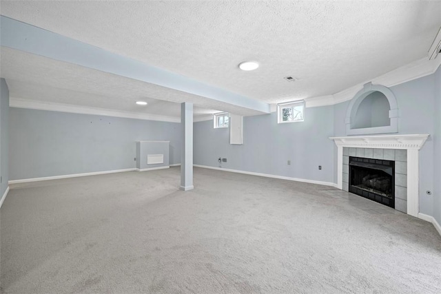 basement with a fireplace, carpet floors, and a textured ceiling