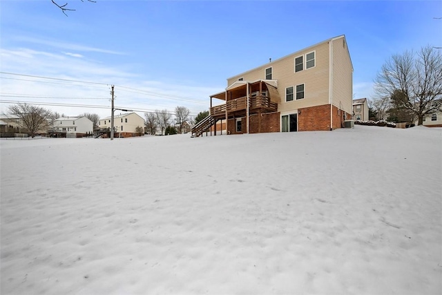 snow covered property featuring a wooden deck