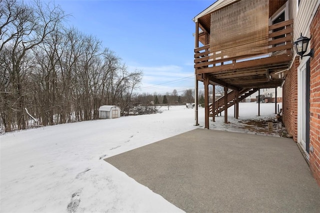 yard covered in snow with a shed