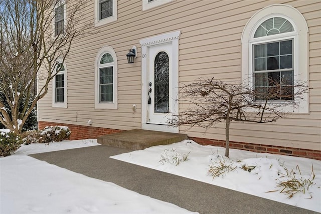 view of snow covered property entrance