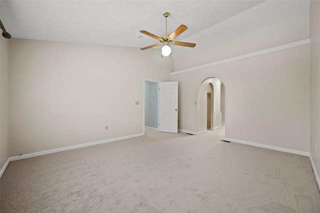 carpeted spare room featuring ceiling fan and vaulted ceiling