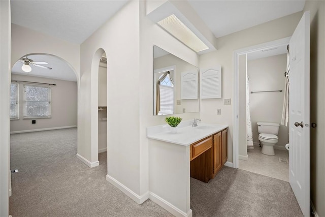 bathroom featuring vanity, ceiling fan, and toilet