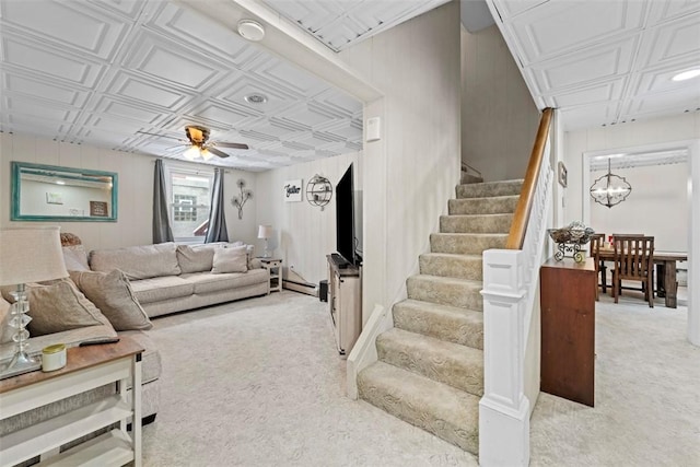 carpeted living room featuring ceiling fan and a baseboard radiator