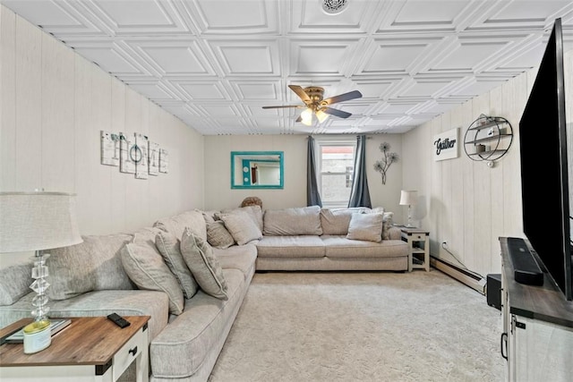 carpeted living room featuring ceiling fan and a baseboard heating unit