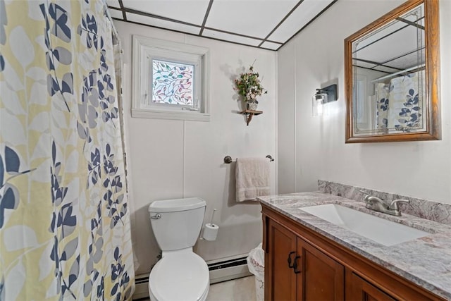 bathroom with toilet, vanity, and a baseboard heating unit