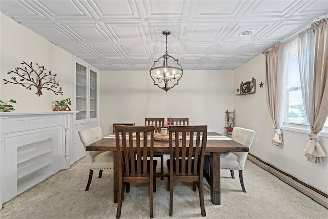 carpeted dining space featuring an inviting chandelier and a baseboard heating unit