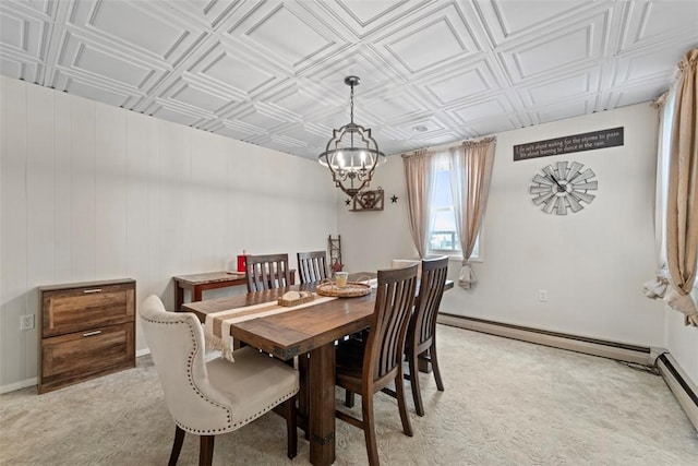 dining room with light carpet, a chandelier, and a baseboard heating unit