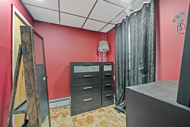 interior space featuring vanity, a baseboard radiator, and a drop ceiling