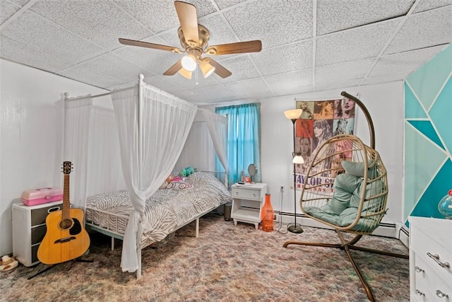 bedroom with a paneled ceiling, ceiling fan, and carpet