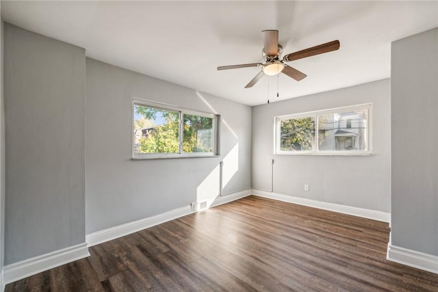 spare room featuring dark hardwood / wood-style flooring and ceiling fan