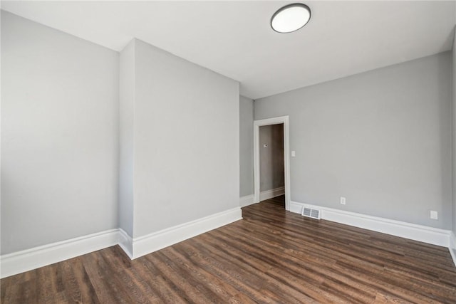 unfurnished room featuring dark hardwood / wood-style floors