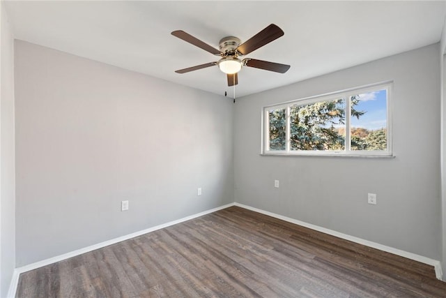 empty room featuring dark hardwood / wood-style flooring and ceiling fan