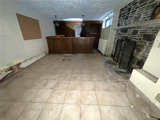 unfurnished living room featuring a textured ceiling and a fireplace