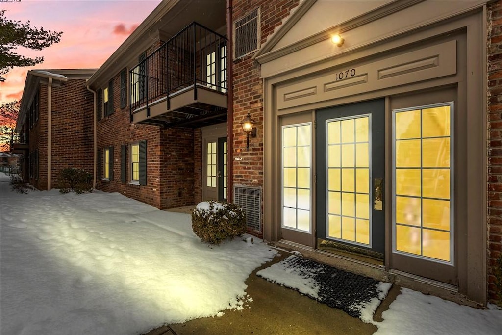 exterior entry at dusk with a balcony