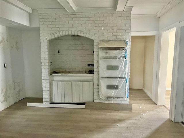 interior space with gas stovetop and ornamental molding