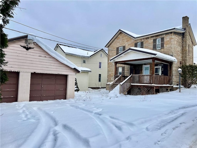 view of front of home featuring covered porch and a garage