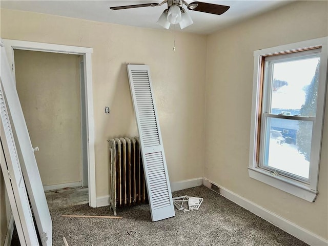 unfurnished bedroom featuring ceiling fan and radiator heating unit