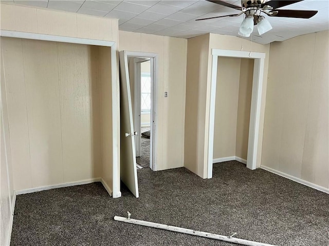 unfurnished bedroom featuring dark colored carpet, ceiling fan, and a closet