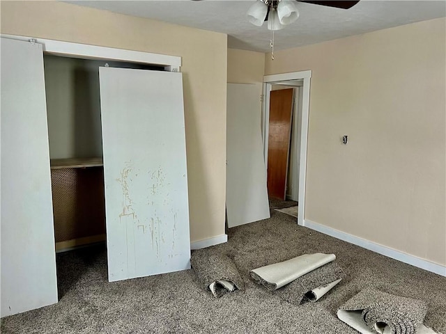 unfurnished bedroom featuring carpet floors, a closet, and ceiling fan