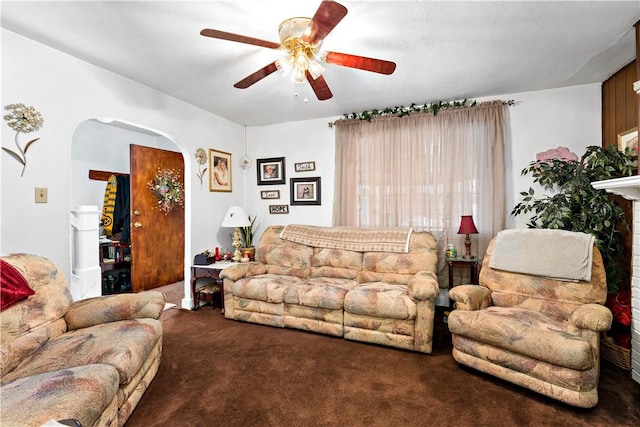 carpeted living room with ceiling fan