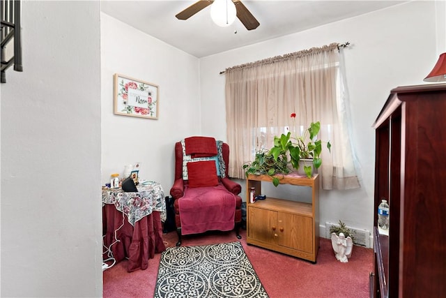 sitting room featuring light carpet and ceiling fan