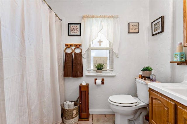 bathroom with toilet, tile patterned floors, and vanity