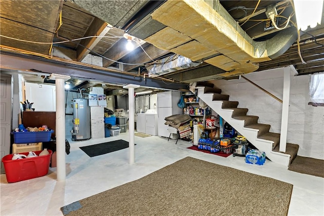 basement with white refrigerator, independent washer and dryer, and gas water heater