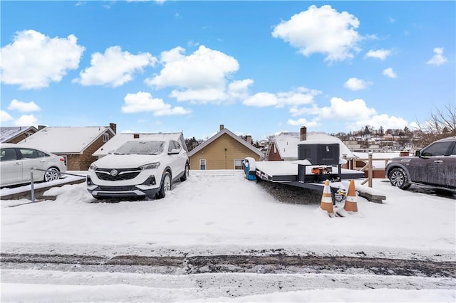 view of snow covered parking area