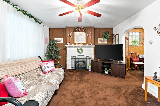 1405 Bellaire Pl, Brookline, PA 15226 - carpeted living area with a ceiling fan, arched walkways, a brick fireplace, and wood walls