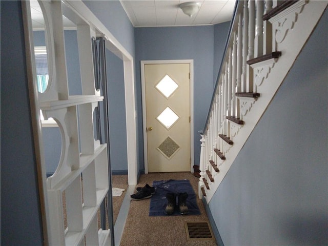 view of carpeted foyer