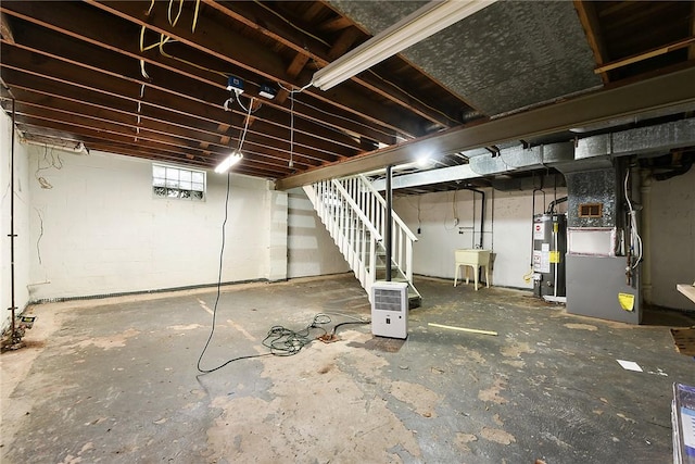 basement with heating unit, sink, and gas water heater