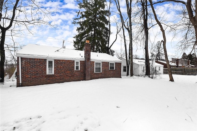 view of snow covered rear of property