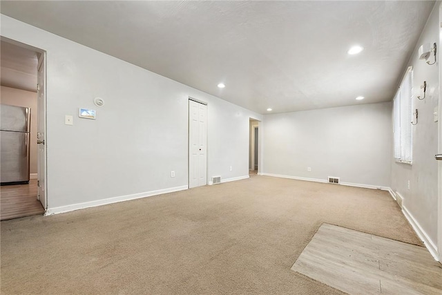 unfurnished room with light colored carpet