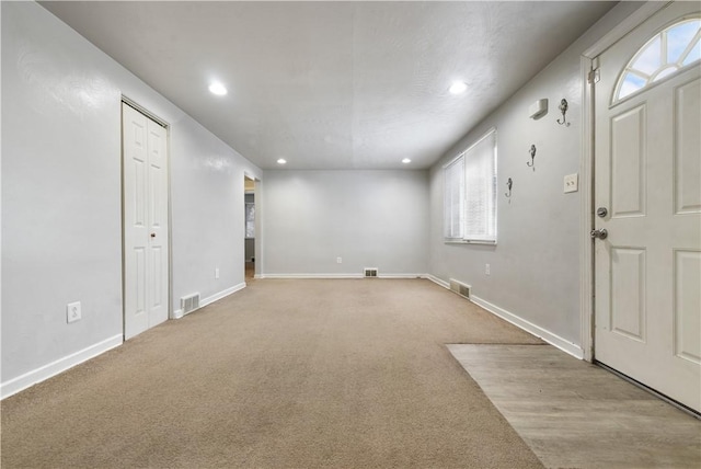 carpeted empty room with plenty of natural light