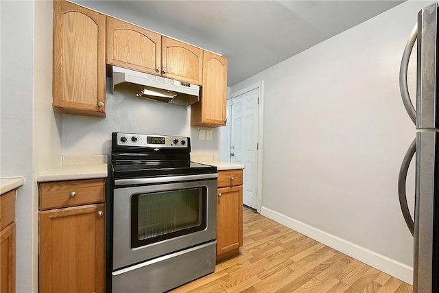 kitchen with light wood-type flooring and appliances with stainless steel finishes